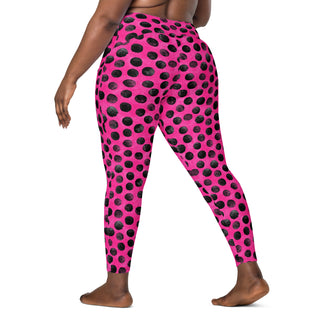 Crossover leggings built for gym sets and running stride - styled with bold neon pink black dots for powered energy